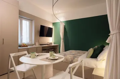 a bedroom with a bed and a table and chairs at Aquacharme in Palermo