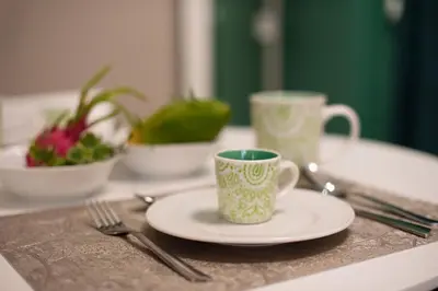 a table with a plate and a cup and a fork at Aquacharme in Palermo