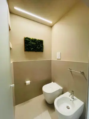 a bathroom with a white toilet and a sink at Aquacharme in Palermo
