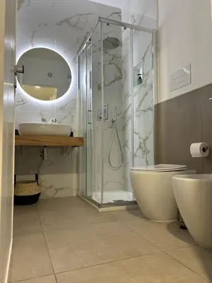 a bathroom with a shower and a toilet and a sink at Matteotti35 in Terrasini