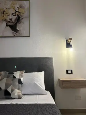 a bedroom with a bed with a picture on the wall at Matteotti35 in Terrasini
