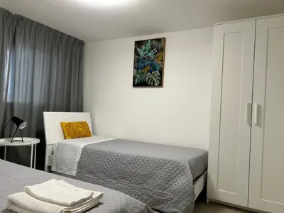 a small bedroom with two beds and a cabinet at Matteotti35 in Terrasini
