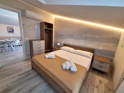 a bedroom with a bed with two towels on it at Casa Vacanze Spiaggia Playa in Castellammare del Golfo