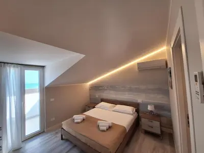 a bedroom with a bed and a large window at Casa Vacanze Spiaggia Playa in Castellammare del Golfo