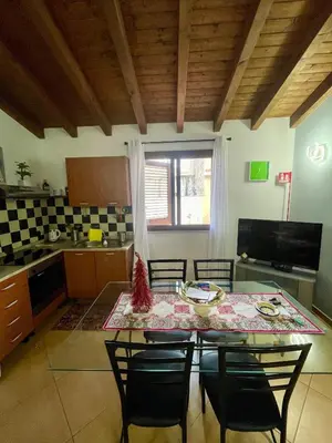 a kitchen and dining room with a table and chairs at SinyHouse in Terrasini