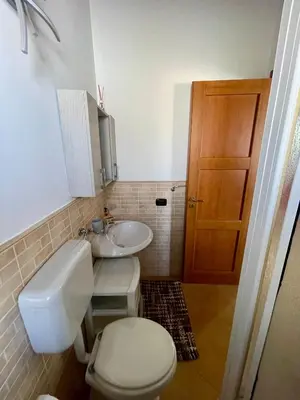 a bathroom with a toilet and a sink at SinyHouse in Terrasini