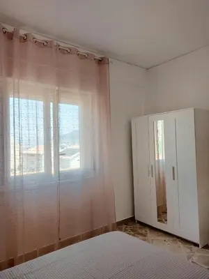 a bedroom with a bed and a window and a cabinet at A casa di Mamma in Palermo