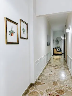a hallway with two pictures on the wall and a couch at A casa di Mamma in Palermo