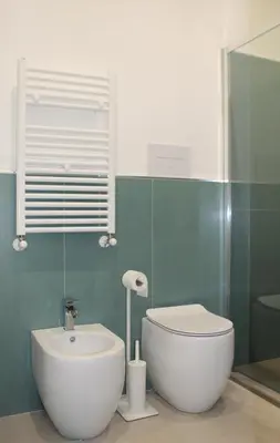 a bathroom with a white toilet and a sink at Villa Mercurio Mondello in Mondello