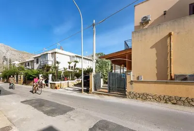 a group of people riding bikes down a street at Casa Karuscia in San Vito lo Capo