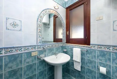 a bathroom with a sink and a mirror at Casa Karuscia in San Vito lo Capo