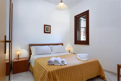 a bedroom with a bed with two towels on it at Casa Karuscia in San Vito lo Capo