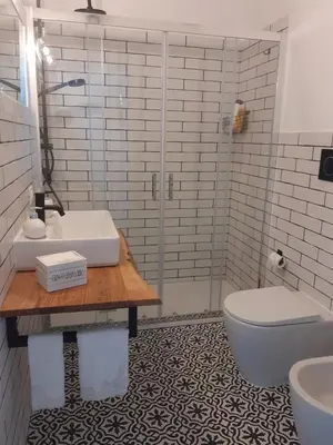 a bathroom with a sink and a toilet and a shower at La casetta di rosario mondello in Palermo