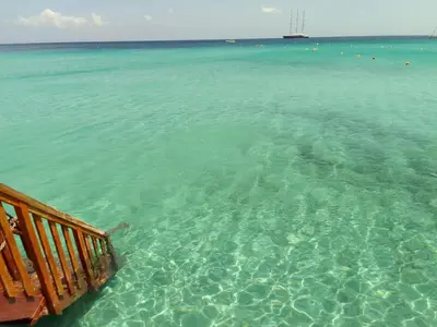 a view of the ocean from a deck in the water at La casetta di rosario mondello in Palermo