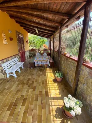 an outdoor patio with a table and a bench at Casa Vacanze Villino Nando in Palermo