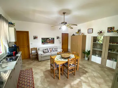 a living room with a table and a couch at Casa Vacanze Villino Nando in Palermo