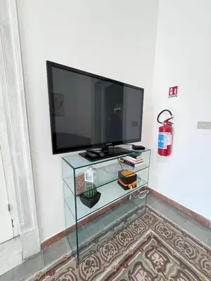 a flat screen tv sitting on top of a glass table at Casetta Alice in Palermo