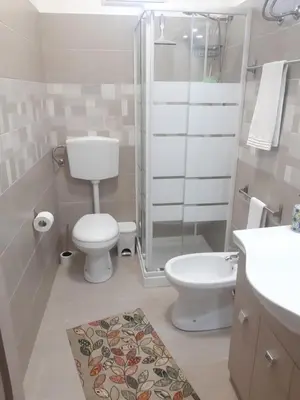a bathroom with a toilet and a shower and a sink at Villa L'orizzonte di calabianca in Castellammare del Golfo