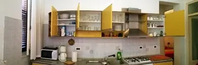 a kitchen with yellow cabinets and a sink at Terrasini Siracasa in Terrasini