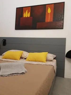 two beds with yellow pillows in a room at appartamento politeama in Palermo