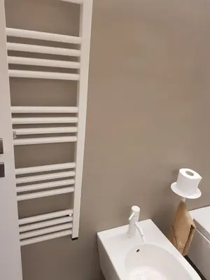 a white bathroom with a sink and a mirror at appartamento politeama in Palermo
