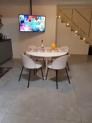 a table and two chairs in a room with a tv at appartamento politeama in Palermo