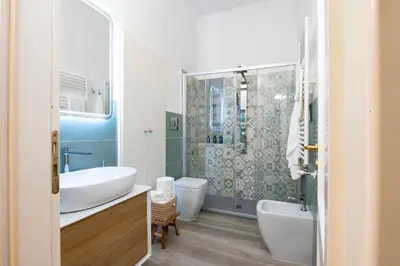 a bathroom with a tub and a sink and a shower at Pothos House in Palermo