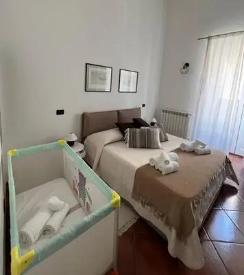 a bedroom with a bed with towels on it at Pothos House in Palermo