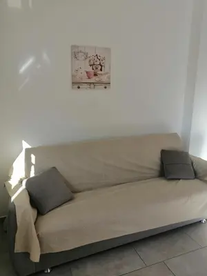 a couch in a living room with a picture on the wall at Residence Mare Azzurro in Balestrate