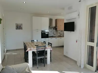 a kitchen with a table and chairs in a room at Residence Mare Azzurro in Balestrate