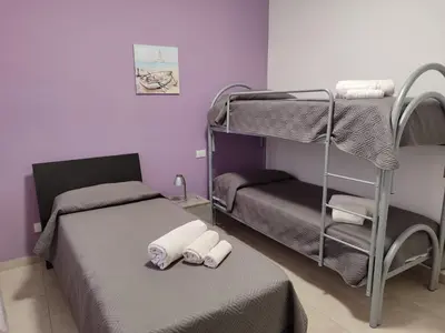 a room with two bunk beds with towels on the bed at Residence Mare Azzurro in Balestrate