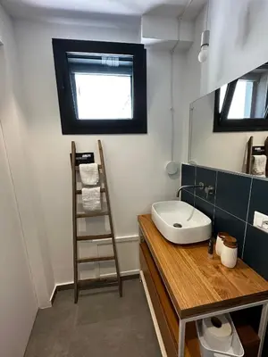 a bathroom with a sink and a ladder in it at Le Gemelle Diverse in Cinisi