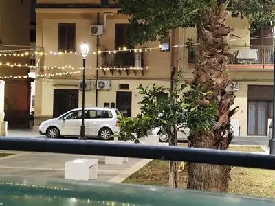 a view of a street with cars parked on the road at La Casetta Nell' Atrio Cavalieri in Bagheria