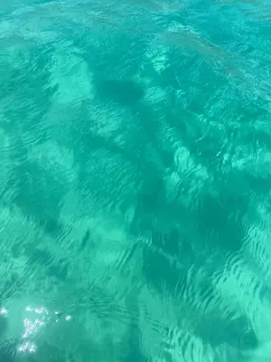 a close up of the blue ocean water at Mondello Sea House in Palermo