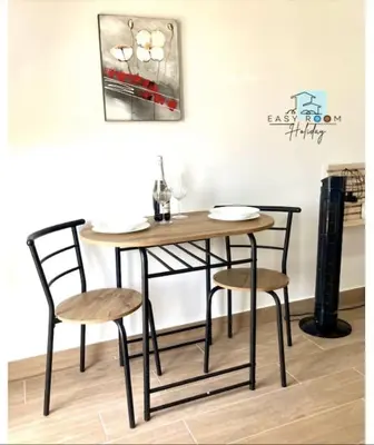 a dining room table and two chairs and a table at Easy Room Holiday in Castellammare del Golfo