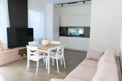 a living room with a couch and a table and chairs at Hotel La Martinica in Ficarazzi