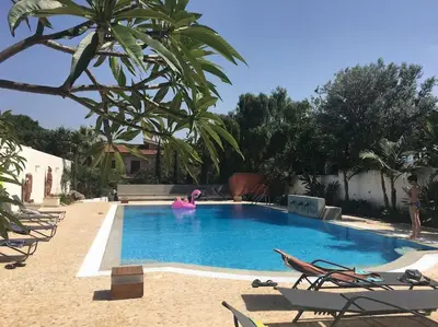 a swimming pool with a pink flamingo in a resort at Villa Elloise in Palermo