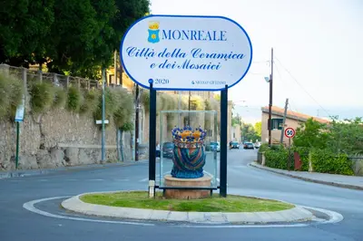 a sign in the middle of a street with a vase at Pozzillo appartament -near the cathedral in Monreale