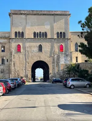 a car driving down a street in front of a building at Porta dei Greci in Palermo