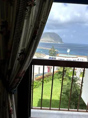 an open window with a view of the ocean at La Scalinatella di Mondello in Palermo