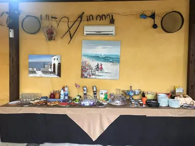 a table with food on it with pictures on the wall at Baglio Pocoroba in Calatafimi