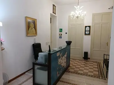 a room with a reception desk and a chandelier at DayBreak B&B in Palermo