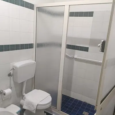 a bathroom with a shower stall with a toilet at DayBreak B&B in Palermo