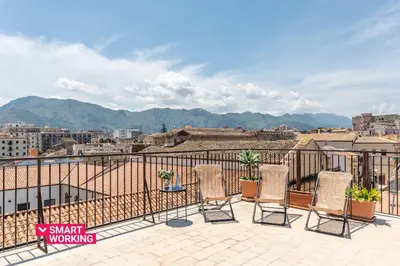 a balcony with chairs and a view of a city at Le terrazze nel cuore della Kalsa by Wonderful Italy in Palermo