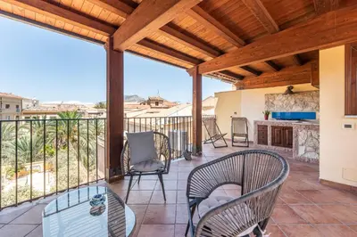 a patio with chairs and a table on a balcony at Le terrazze nel cuore della Kalsa by Wonderful Italy in Palermo