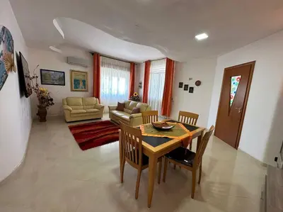 a living room with a table and chairs and a couch at Casa vacanze Elisir Del Golfo in Alcamo