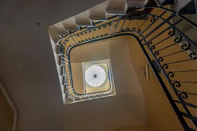 a spiral staircase in a building with a window at Amari Elegant Apartment by Wonderful Italy in Palermo