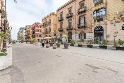 a street in a city with buildings and plants at Amari Elegant Apartment by Wonderful Italy in Palermo