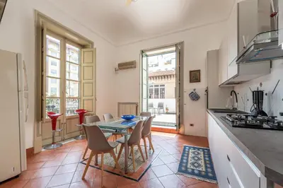 a kitchen and dining room with a table and chairs at Amari Elegant Apartment by Wonderful Italy in Palermo