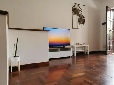 a living room with a large flat screen tv at Casa Antigone 99 in Mondello